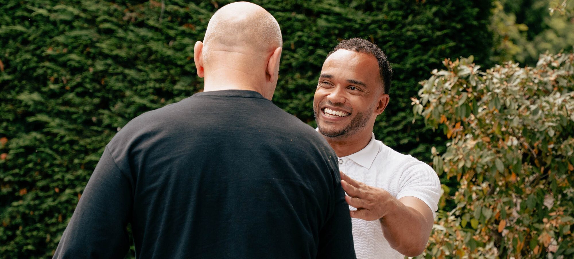 Two Evtec colleagues in conversation outside the building