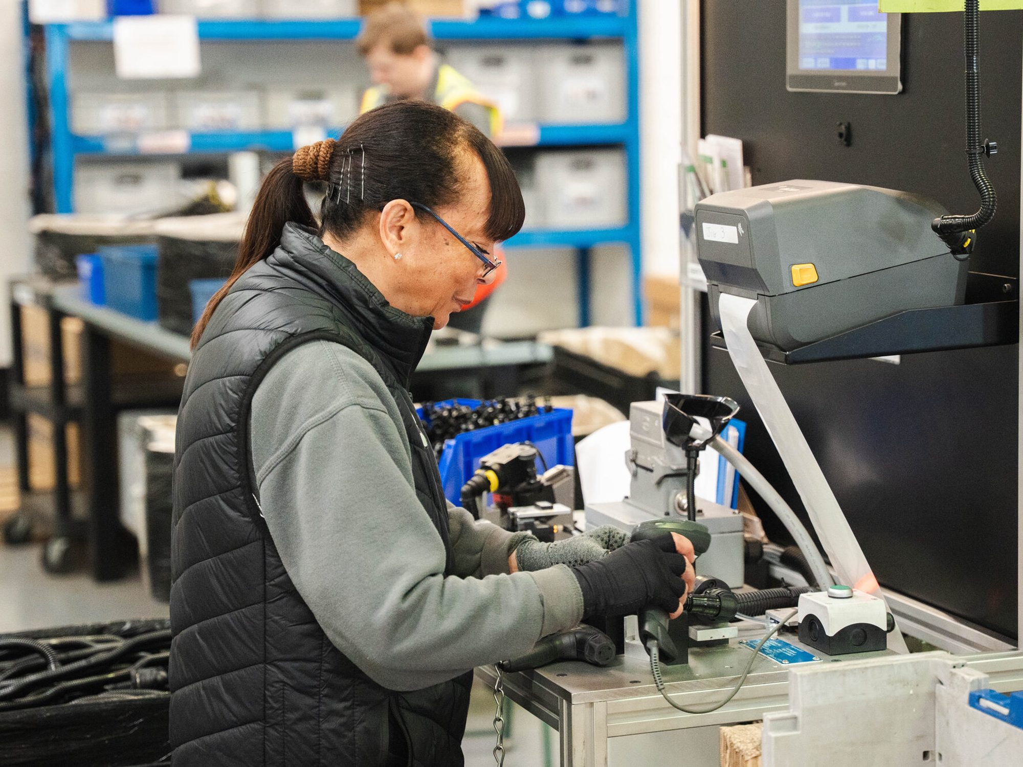 An Evtec team member working at a test station on the production line