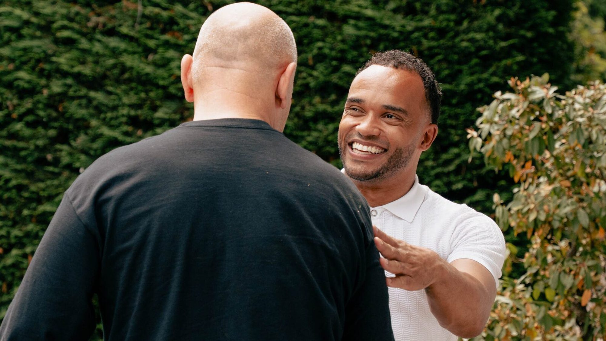 Two Evtec colleagues in conversation outside the building